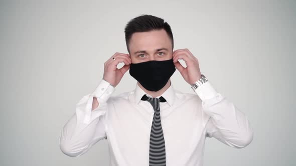 Middle Age Manager Man Take Off Black Prevention Mask on White Isolated Background. Protection