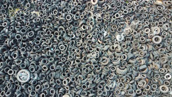 Pile of old tires and wheels for rubber recycling. alt