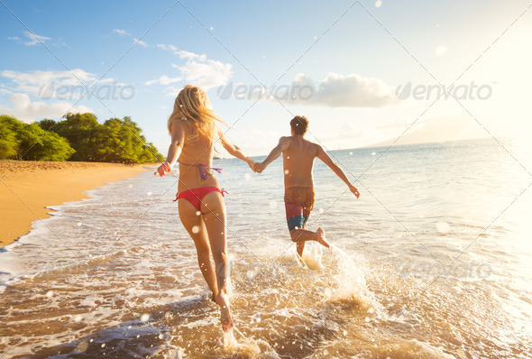 Happy Couple on Tropical Beach at Sunset - Stock Photo - Images