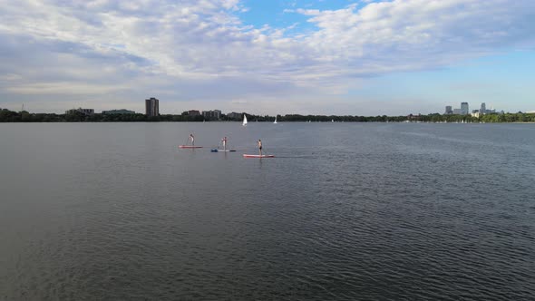 Paddelers at Lake Calhound Minneapolis during summer time. summer water activities alt