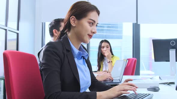 Asian employee officer attractive positive smile woman working on desktop alt