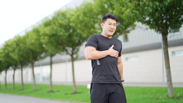 young adult asian athlete while jogging chest injury, severe heart attack pain  alt