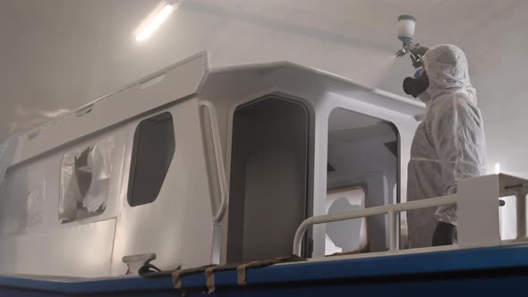 Worker Painting Top of Boat alt