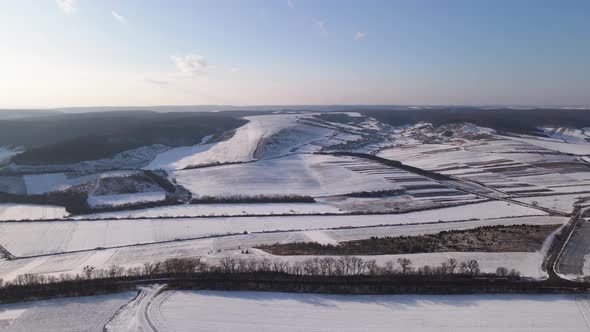 Aerial Drone View Fly Over the Snowy Field Winter Landscape
