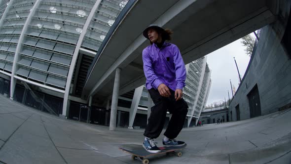 Sporty Man Jumping on Skateboard Outside alt