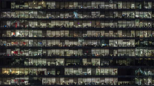 View of office windows with working people