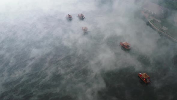 Aerial View of Sunrise with Fog Over Ban Rak Thai Chinese Village Near a Lake in Mae Hong Son alt