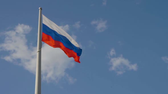 Flag of Russia on the Background of the Sky with Clouds