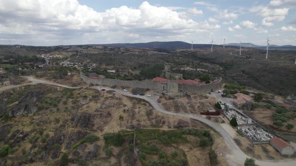 Aerial arc shows Sortelha Fortress, defensive wall and surrounding landscape
