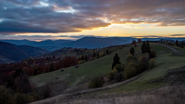 Bright Sunset Behind Mountains in Highland at Autumn Dusk