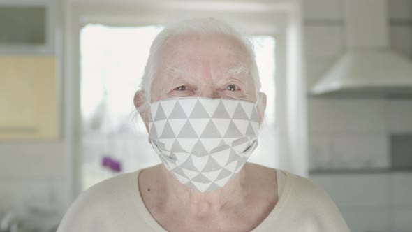 Portrait Of Old Woman In Medical Mask. Woman Protects Herself From Infections In Pandemic alt