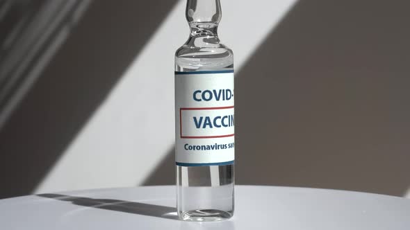 Coronavirus Covid Vaccines Rotate on a White Background in a Medical Laboratory alt