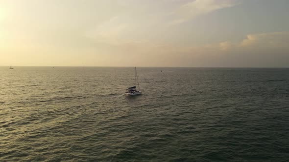 Drone Video of a Yacht Crossing the Water at Sunset