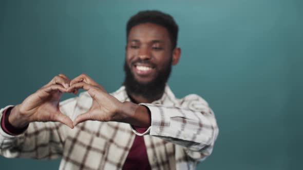 A Handsome African Man is Showing a Heart From His Hands Slow Motion alt