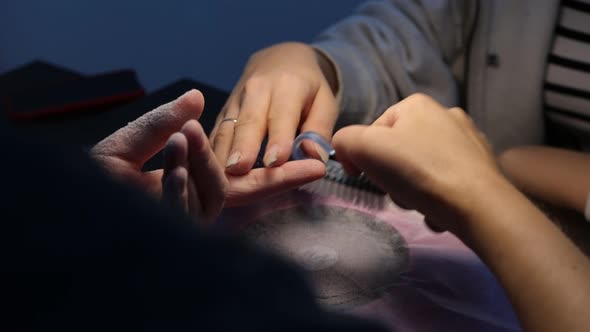 Anonymous Beautician Doing Manicure to Female Client