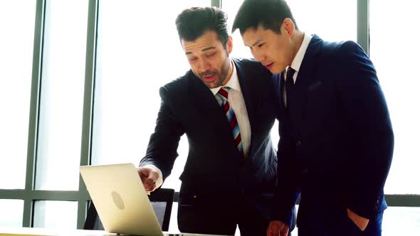 Two Business People Talk Project Strategy at Office alt