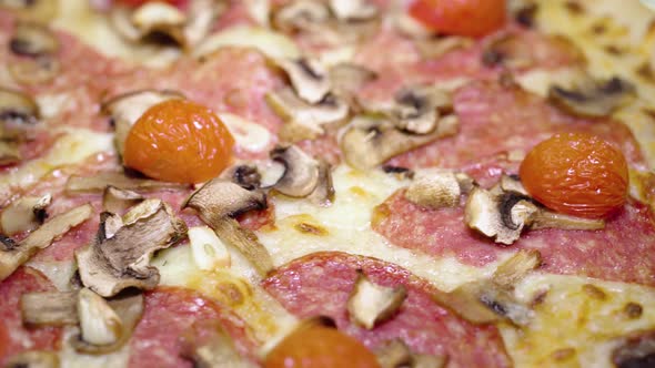 Fresh Round Pizza with Tomatoes and Mozzarella Cheese Turns on a Table