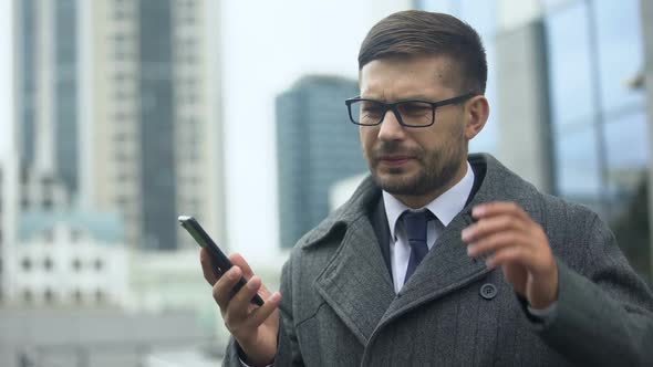 Businessman Feeling Pain in Head Talking Phone Outdoors, Nervous Tension, Spasms