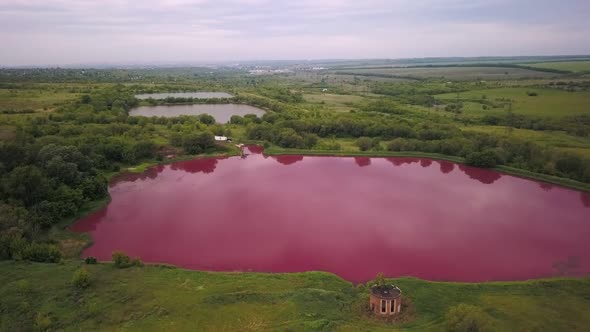 Aerial Shot on Unusual Pink Lake in Industrial Zone, Colored Water By