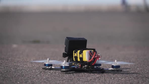 FPV Racing Drone Takes Off From the Asphalt Surface