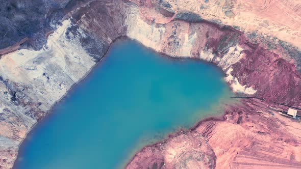 Lake with Blue Water in a Sandyclay Quarry  Clouds are Reflected in the Water  Aerial Shot alt