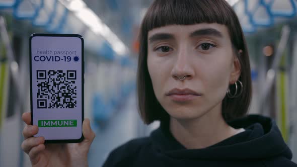 Portrait View of the Short Haired Pierced Woman Calmly Looking at the Camera and Showing Vaccine alt