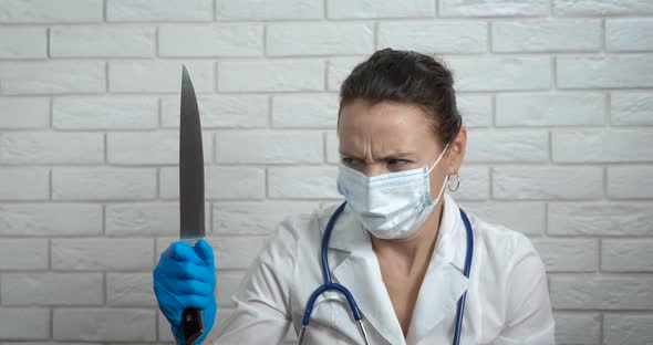 Doctor Looking at Knife alt