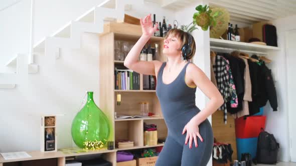 adult woman indoor listening music dancing and screaming alt