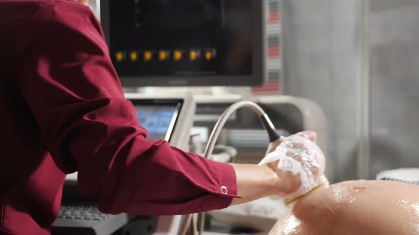 Prenatal Testing with Ultrasonography. Ultrasound Specialist Examines Pregnant Woman, Close-up alt