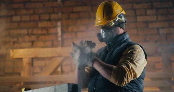 Male Builder Cleaning Nose During Work alt