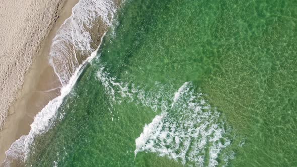 Aerial View of Clear Turquoise Sea and Waves alt