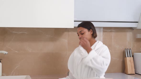 A AfricanAmerican Woman Came to the Kitchen in the Morning in a White Coat