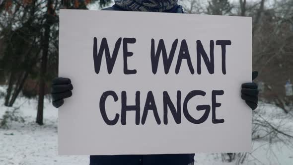 We Want Change Message Held By Adult Male Citizen In Social Justice Protest alt
