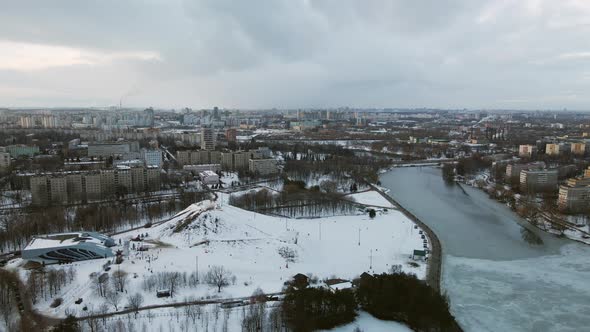 Suburb of a big city. City block from the height of the flight. Pond in the city park. alt