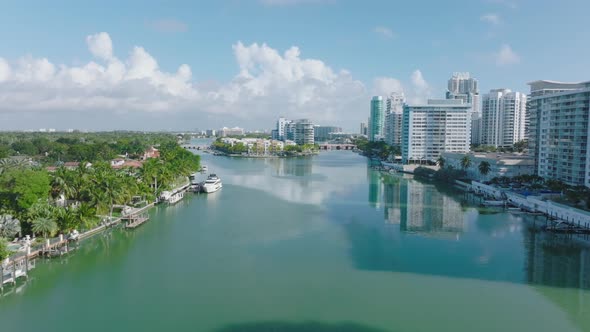 Sunny Day in Town Forwards Fly Above Water Surface Lined By Modern Multistorey Residential Buildings alt
