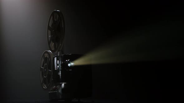 Dark Movie Theater. Projector Illuminated By Lights Broadcasts a Movies alt