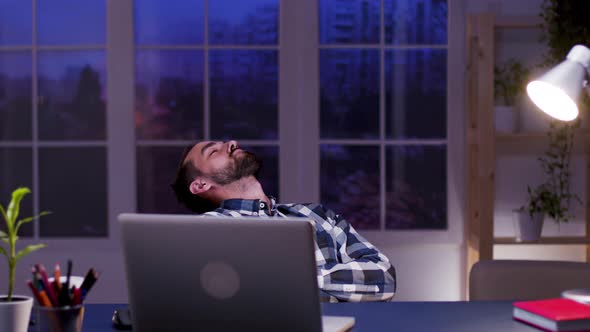 Tired Businessman Sleeping on Chair in His Home Office alt