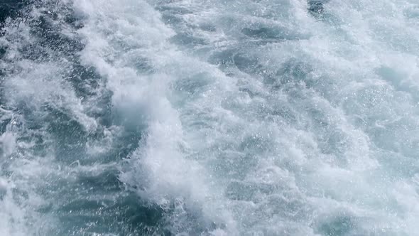 Closeup wake and splashing waters of a motorboat
