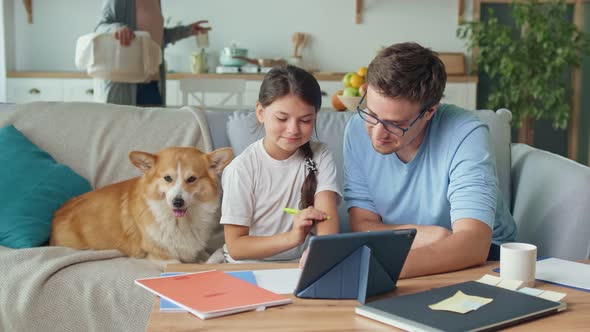 Young Father Helping his Cute Daughter Schoolgirl with Research. Private education concept alt
