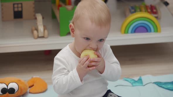 Kid Eats an Apple Sitting on the Floor and Watching Tv alt