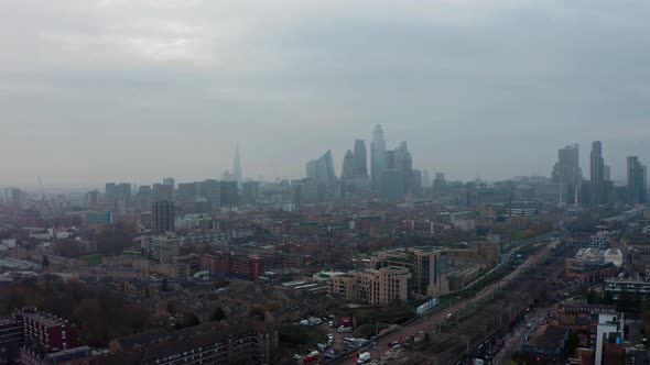 High slider drone shot of Central London skyline on a hazy day alt