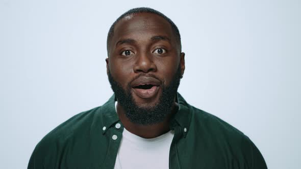 Portrait of Smiling African Giving Thanks at Camera on Grey Background