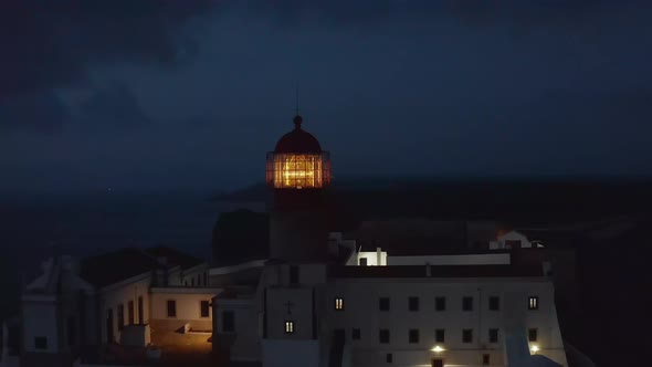 Scenic Aerial Drone View of Lonely Lighthouse at Sunset Dusk Circle Pan Reveal Background Sea Ocean alt