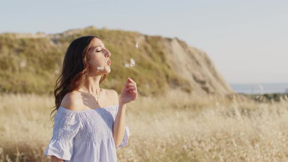 Dandelion Plants in the Countryside with Girl Relaxing in Nature alt
