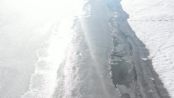 Frozen lake surface by early morning 4K drone video alt