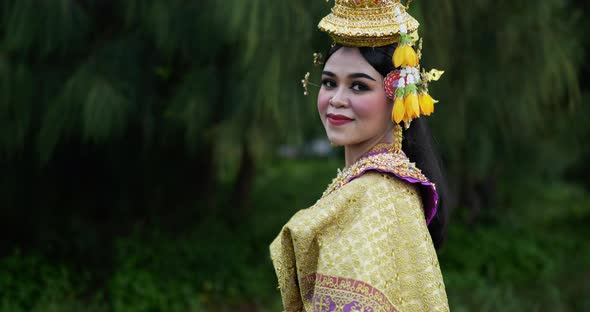 Thai woman in traditional dress looking at camera alt