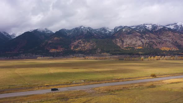 Teton Range Meadow and Road on Autumn Cloudy Day alt