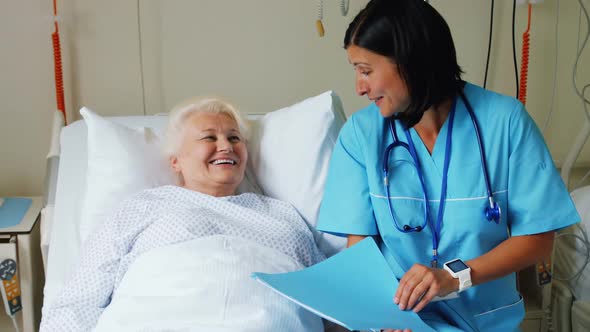 Female doctor discussing report with senior patient alt