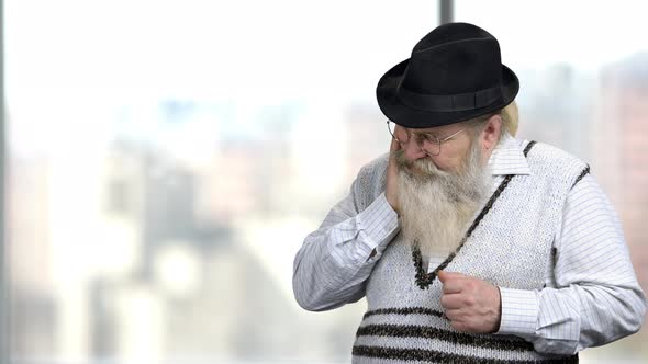 Elderly Bearded Man with Thoughtful Expression. alt