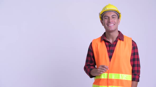 Young Happy Hispanic Man Construction Worker Touching Something